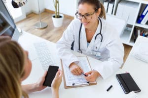 Female doctor explaining diagnosis to her patient.